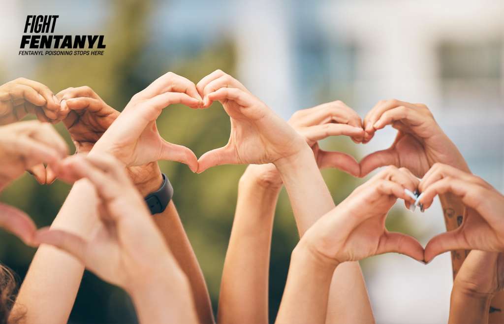 Group of hands making hearts