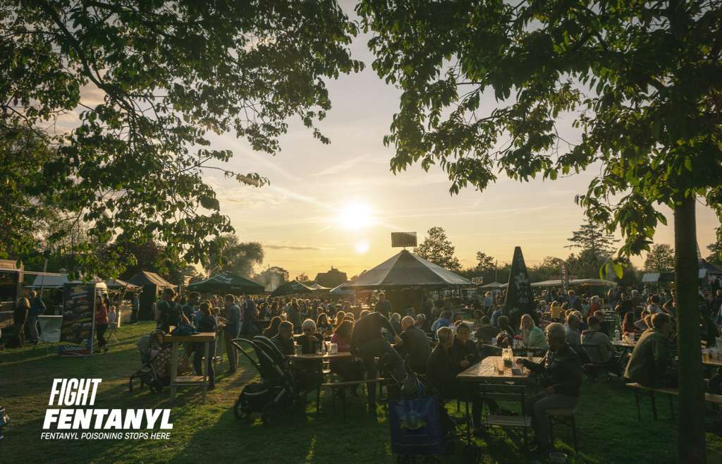 Lots of people gathering outdoors at a summer community festival