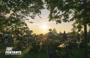 Lots of people gathering outdoors at a summer community festival