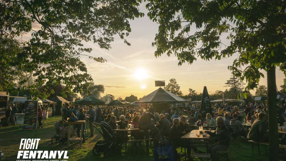 Lots of people gathering outdoors at a summer community festival